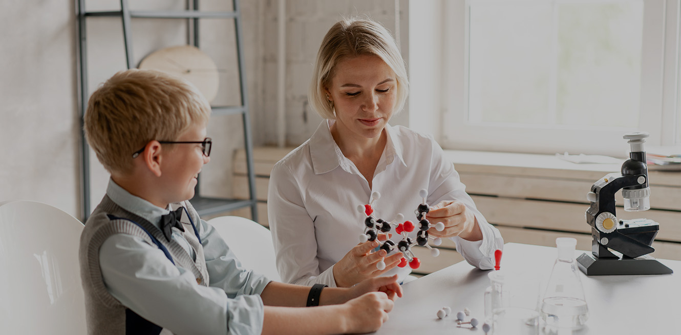 Female science tutor in Charlotte studying chemistry with student